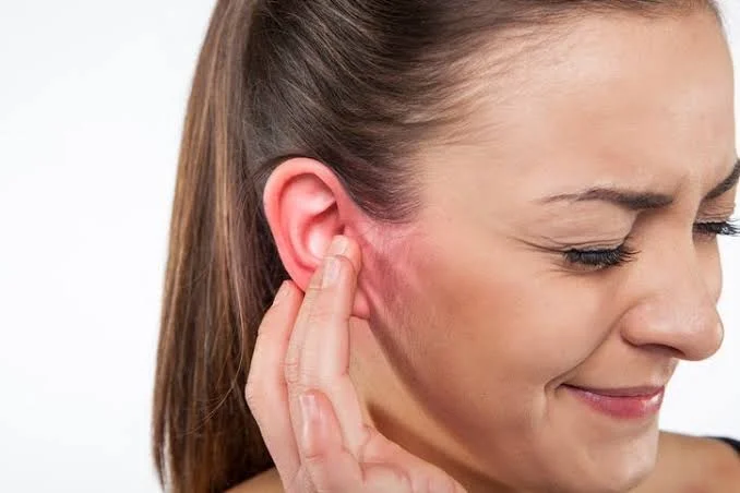 Woman touching inflamed painful ear suffering from adult ear infection at Center of ENT Lahore