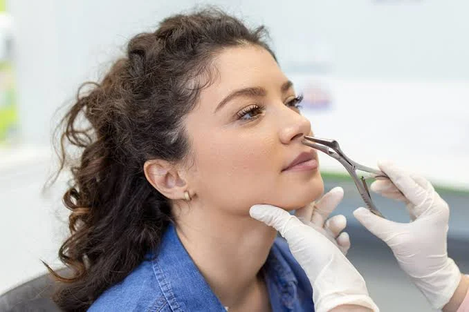 Doctor conducting anterior rhinoscopy examination for chronic sinusitis diagnosis at Center of ENT Lahore