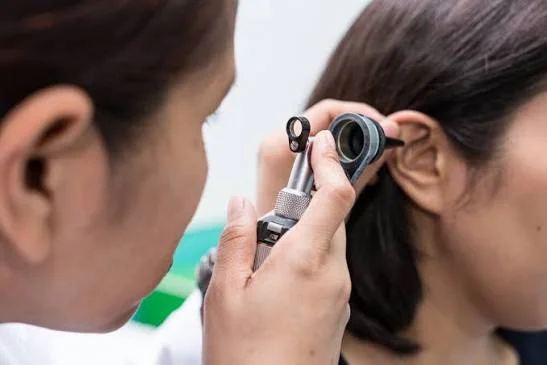 ENT specialist using an otoscope to examine a patient ear canal at Center of ENT Lahore