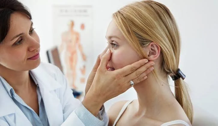 ENT surgeon examining patient nose bridge and nasal bone structure at Center of ENT Lahore
