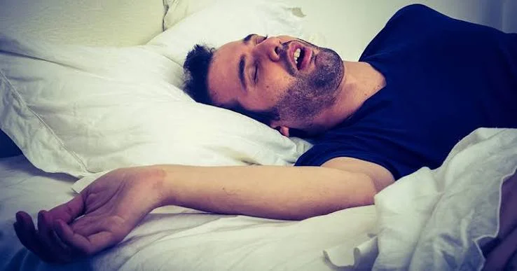 Sleeping man with mouth open snoring and experiencing sleep apnea symptoms at Center of ENT Lahore